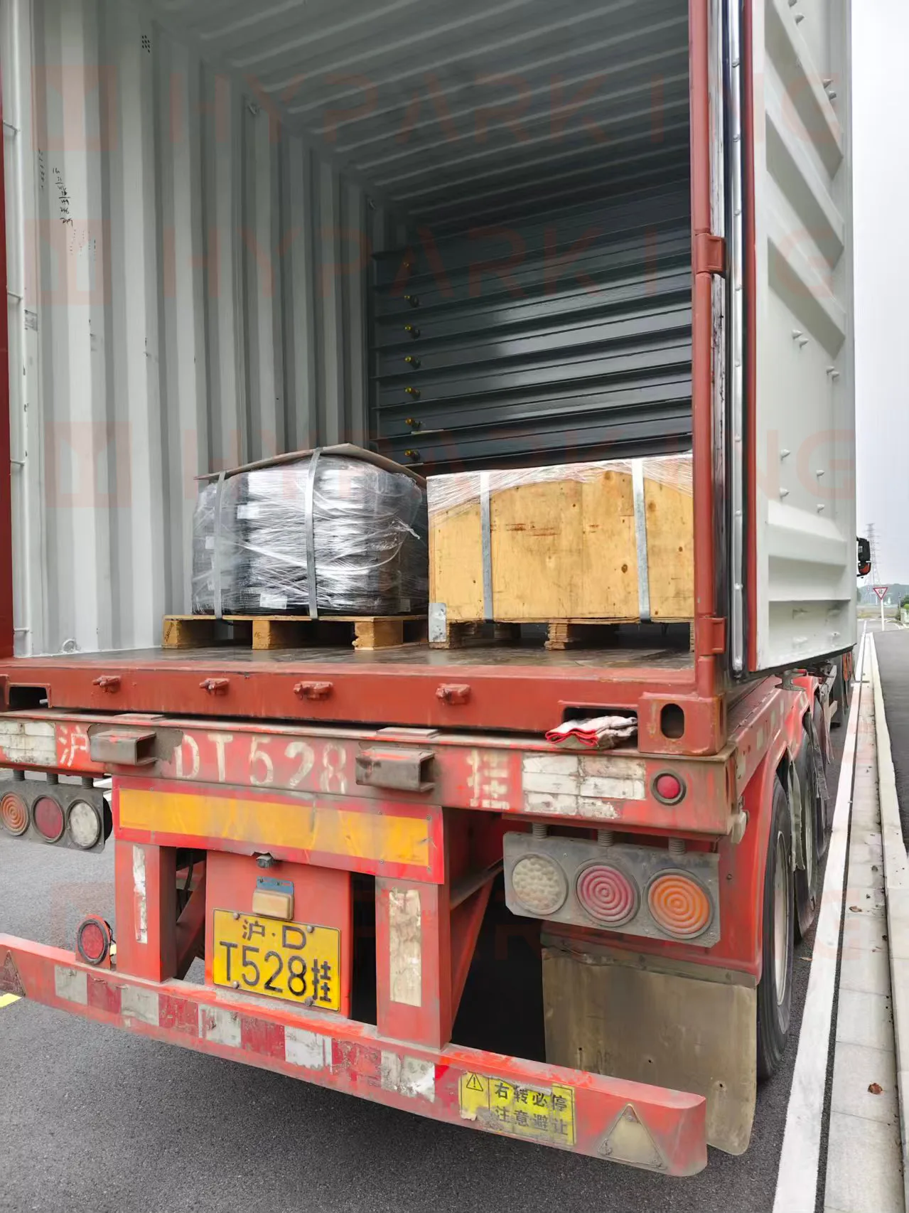 Container on a flatbed trailer departing the Shanghai factory for the port