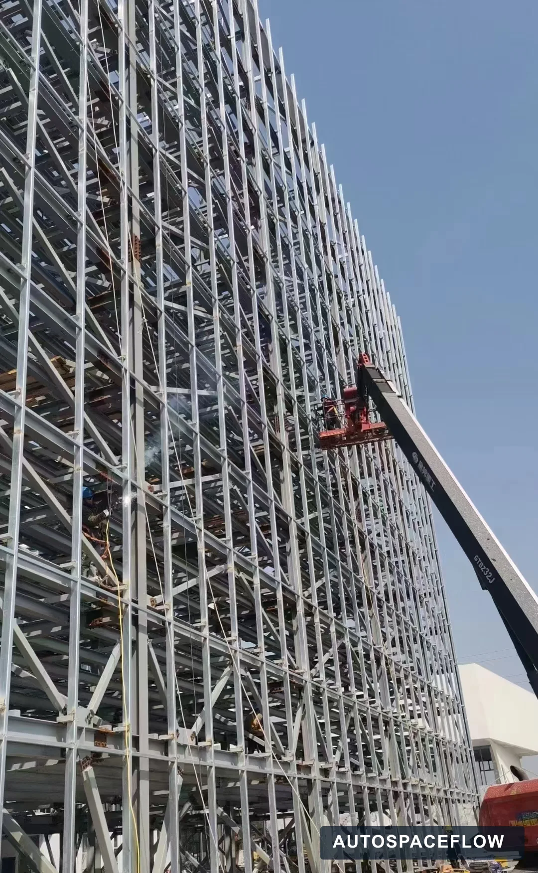 Installation crew working from an elevated platform on the Romania pallet tower parking structure