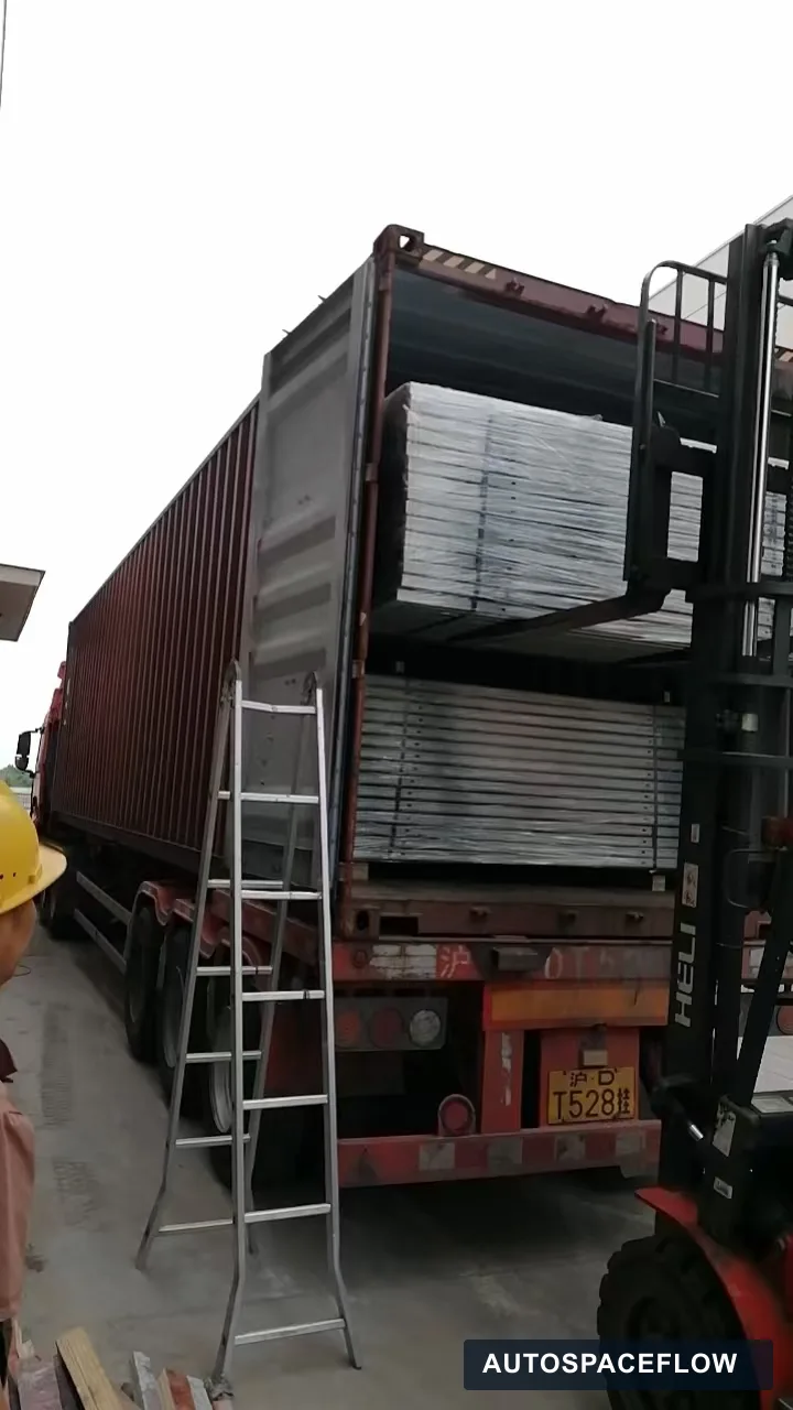 Wrapped puzzle parking platforms being loaded into a shipping container for delivery to Vietnam